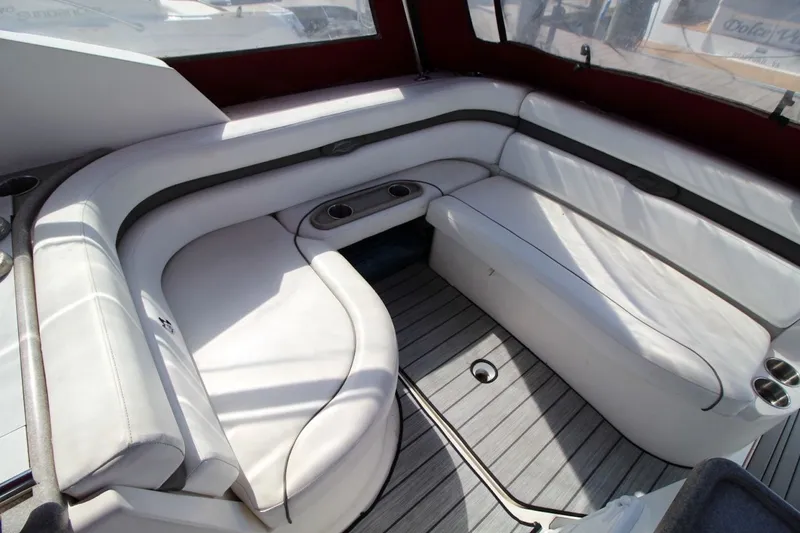 Slide: The Image of 2008 Rinker 280 Express Cruiser interior with white seating and wood flooring. - 12