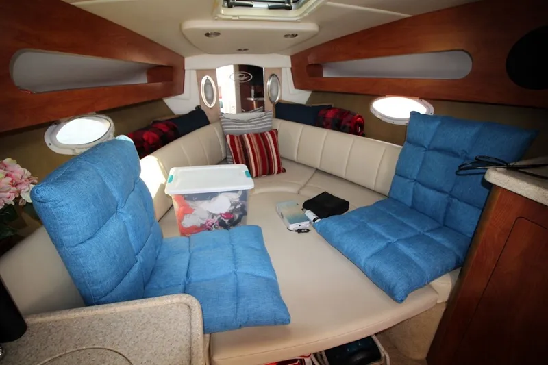 Slide: The Image of Interior of 2008 Rinker 280 Express Cruiser with blue cushions and storage. - 17