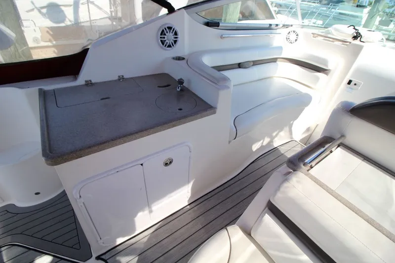 Slide: The Image of 2008 Rinker 280 Express Cruiser interior with seating and kitchenette area. - 13