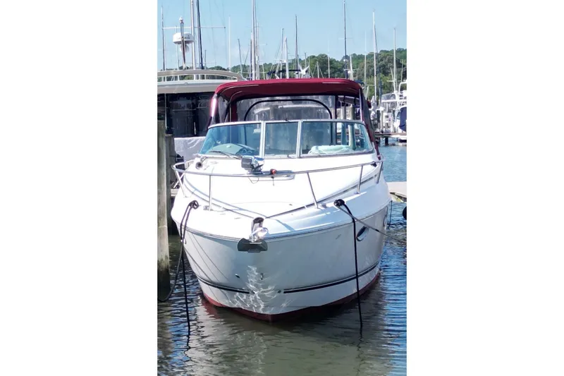 Slide: The Image of 2008 Rinker 280 Express Cruiser docked at marina, front view. - 3