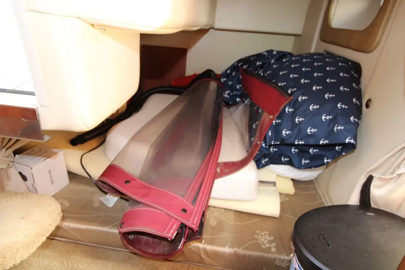 Slide: The Image of Interior storage area of a 2008 Rinker 280 Express Cruiser with nautical-themed items. - 20