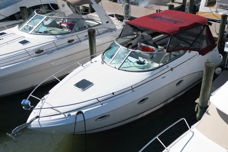 Slide: The Image of 2008 Rinker 280 Express Cruiser docked with red canopy, white hull. - 7