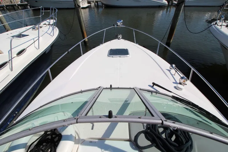 Slide: The Image of 2008 Rinker 280 Express Cruiser docked at marina, view from bow. - 8
