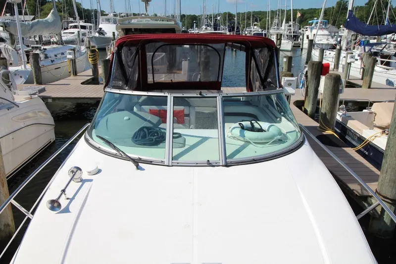 Slide: The Image of 2008 Rinker 280 Express Cruiser docked at marina, surrounded by other boats. - 9