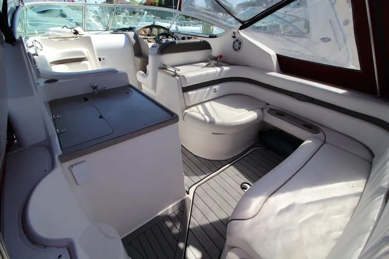 Slide: The Image of 2008 Rinker 280 Express Cruiser interior with seating and helm, showcasing luxury boat design. - 11