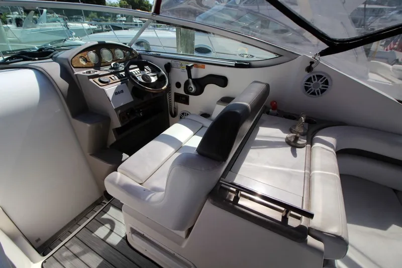 Slide: The Image of 2008 Rinker 280 Express Cruiser cockpit with steering wheel and seating area. - 14