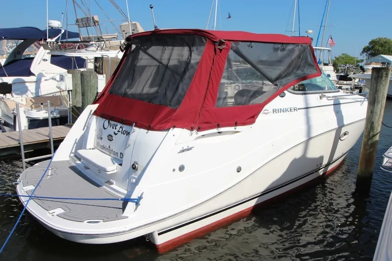 The Image of 2008 Rinker 280 Express Cruiser docked with red canopy in marina. - 0