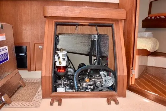 Slide: The Image of Engine compartment of a 2004 Island Packet 370 sailboat, showcasing mechanical components. - 26