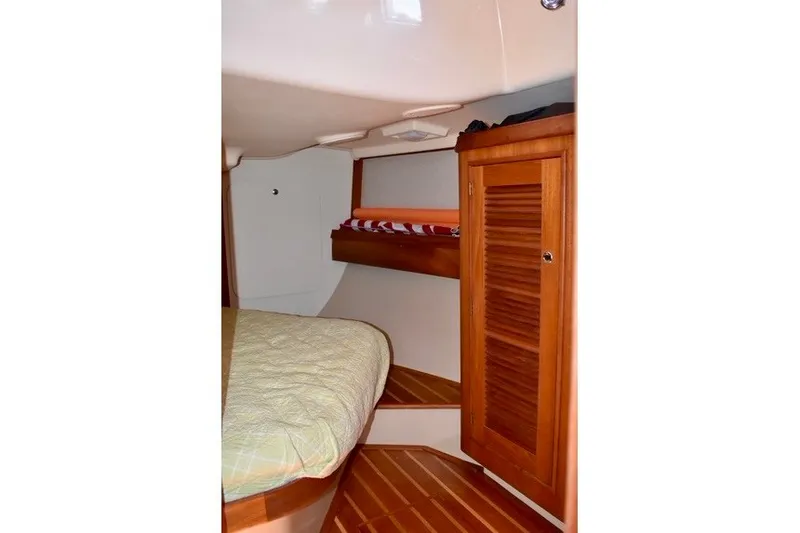 Slide: The Image of Interior cabin of 2004 Island Packet 370 sailboat with wooden cabinetry and bed. - 24