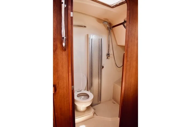 Slide: The Image of Bathroom interior of 2004 Island Packet 370 yacht, featuring toilet and shower. - 21