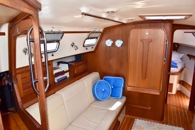 Slide: The Image of Interior of 2004 Island Packet 370 sailboat with cozy seating and wooden finishes. - 14