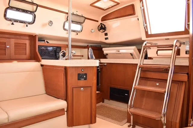 Slide: The Image of Interior of 2004 Island Packet 370 sailboat with wooden cabinetry and seating. - 18