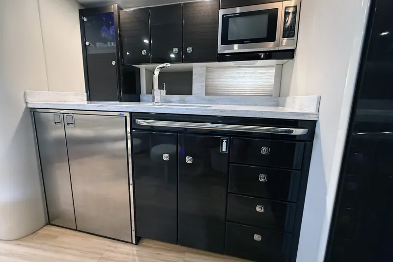 Slide: The Image of Modern kitchen in a 2016 Formula 40 Performance Cruiser with sleek cabinetry and stainless steel appliances. - 22