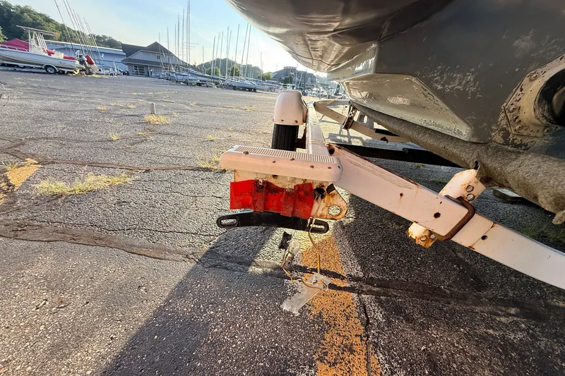 Slide: The Image of Trailer hitch of a 2014 Zodiac Milpro SR 4.70 boat in a marina parking lot. - 18