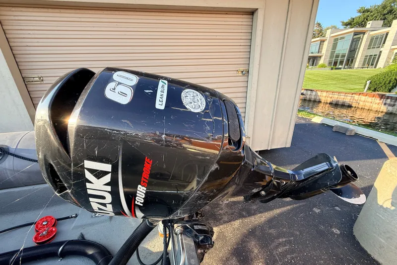 Slide: The Image of Outboard motor on a 2014 Zodiac Milpro SR 4.70 boat, Suzuki 60 horsepower. - 22