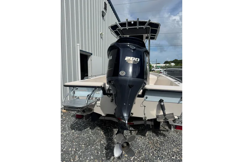 Slide: The Image of 2003 Pathfinder 2200 V boat with Yamaha 200 outboard motor, parked outdoors. - 4