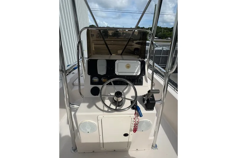 Slide: The Image of 2003 Pathfinder 2200 V boat console with steering wheel and controls. - 2