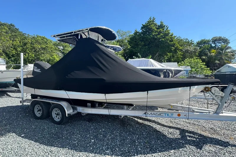 Slide: The Image of 2003 Pathfinder 2200 V boat covered on trailer, parked outdoors. - 9