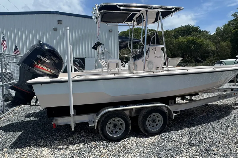 The Image of 2003 Pathfinder 2200 V boat on trailer with Yamaha outboard motor, parked outdoors. - 0