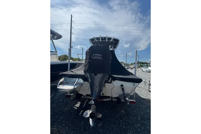 Slide: The Image of 2003 Pathfinder 2200 V boat with Yamaha engine cover, parked on gravel lot. - 10