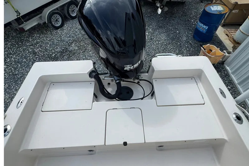 Slide: The Image of 2003 Pathfinder 2200 V boat with powerful outboard motor, parked on gravel. - 8