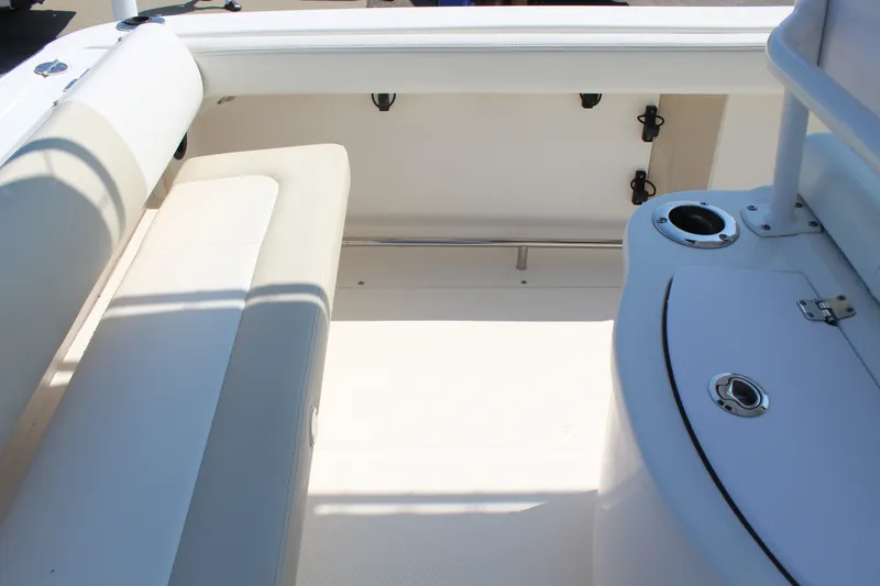 Slide: The Image of The image shows the interior of a 2015 Robalo R222 Center Console boat with white upholstery. - 24
