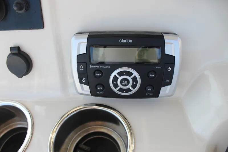 Slide: The Image of A Clarion audio system is mounted on a boat console, surrounded by cup holders. - 14