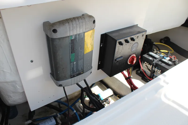 Slide: The Image of Electrical panel and battery inside a boat, featuring wiring and connections. - 22