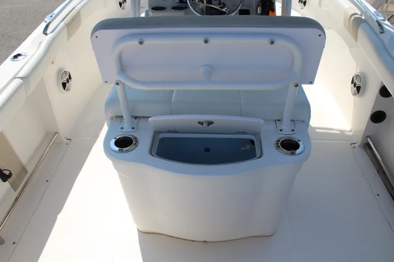 Slide: The Image of The image shows the cockpit of a Robalo R222 Center Console boat with a bench seat and cup holders. - 10