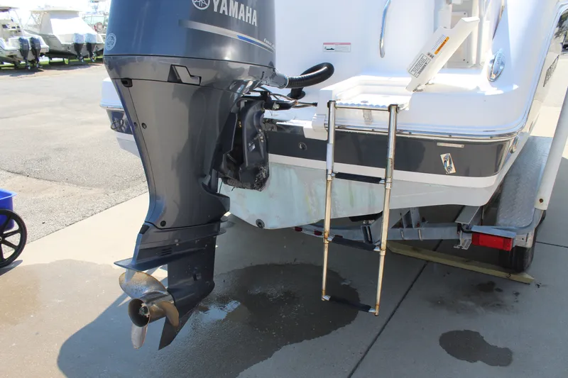 Slide: The Image of A 2015 Robalo R222 Center Console with a Yamaha outboard motor and a swim ladder at the stern. - 7