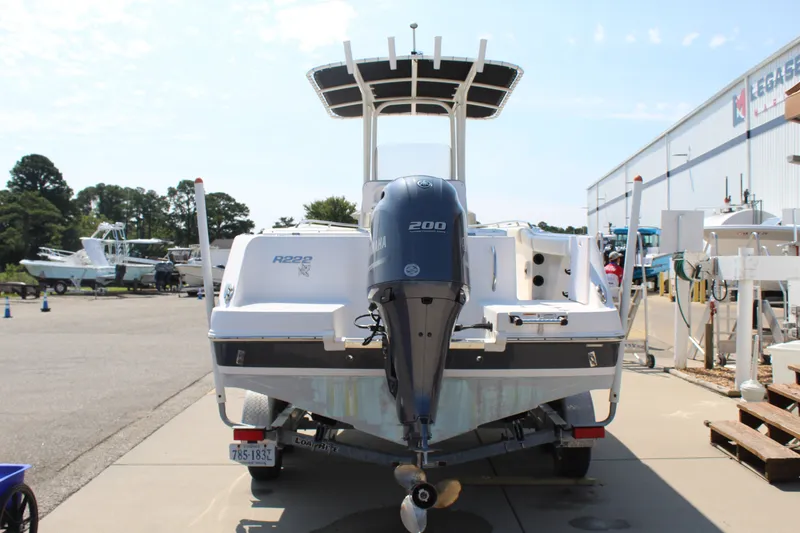 Slide: The Image of A 2015 Robalo R222 Center Console boat on a trailer, featuring a 200 HP outboard motor. - 4