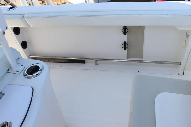 Slide: The Image of The image shows the interior of a 2015 Robalo R222 Center Console boat with white upholstery. - 25