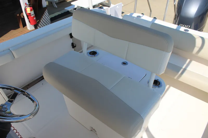 Slide: The Image of The 2015 Robalo R222 Center Console features a cushioned bench seat and a steering wheel. - 16