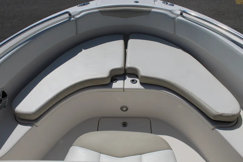Slide: The Image of The front of a 2015 Robalo R222 Center Console boat with cushioned seating areas. - 19