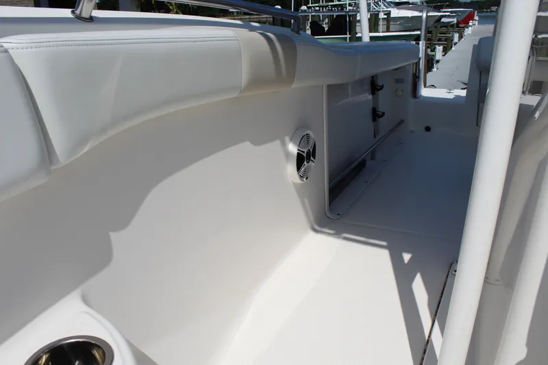 Slide: The Image of The image shows the interior of a 2015 Robalo R222 Center Console boat with white upholstery. - 18