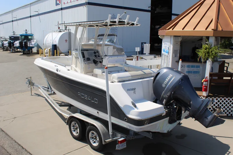 Slide: The Image of A 2015 Robalo R222 Center Console boat on a trailer, featuring a Yamaha outboard motor. - 3