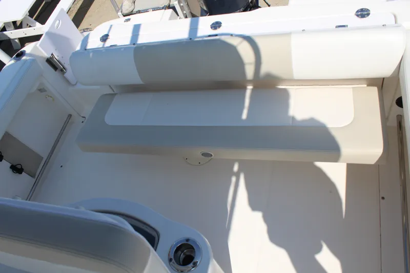 Slide: The Image of The image shows the seating area of a 2015 Robalo R222 Center Console boat. - 8