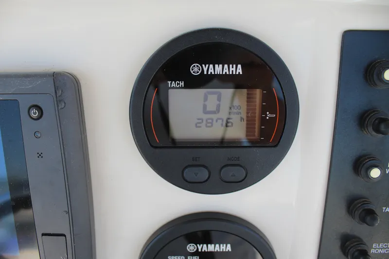 Slide: The Image of Close-up of a Yamaha tachometer on a boat, displaying 2876 hours of operation. - 13
