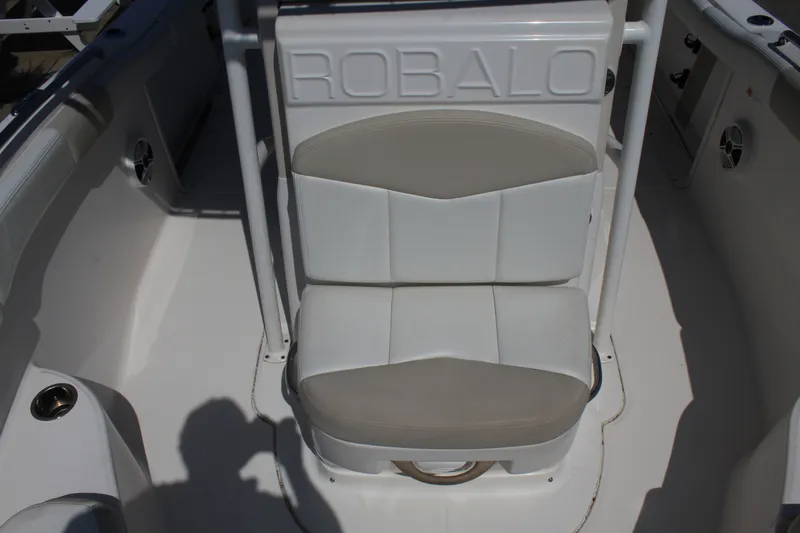 Slide: The Image of A seating area on a 2015 Robalo R222 Center Console boat, featuring cushioned seats. - 20