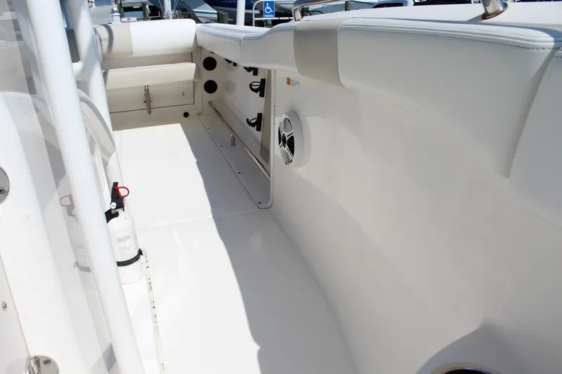 Slide: The Image of The image shows the cockpit of a 2015 Robalo R222 Center Console boat with white upholstery. - 17