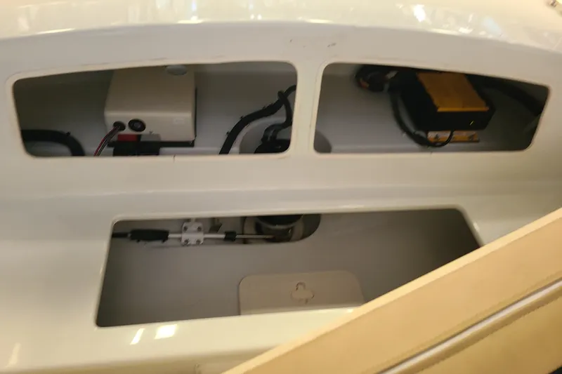 Slide: The Image of Interior view of a 2019 Duffy 18 boat showing electrical components and wiring. - 17