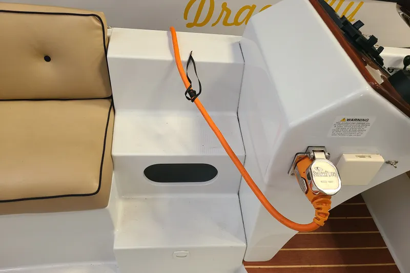 Slide: The Image of Interior of a 2019 Duffy 18 boat showing seating and electrical connection. - 19