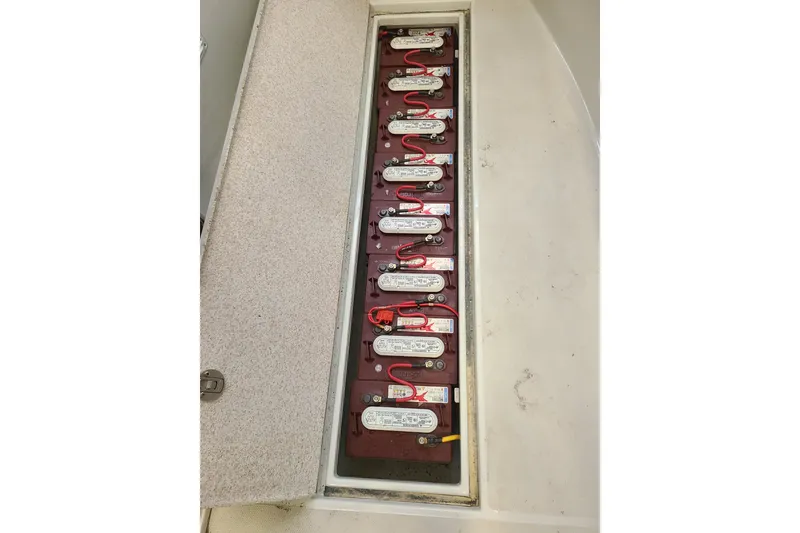 Slide: The Image of Battery compartment of a 2019 Duffy 18 boat, showcasing multiple connected batteries. - 20