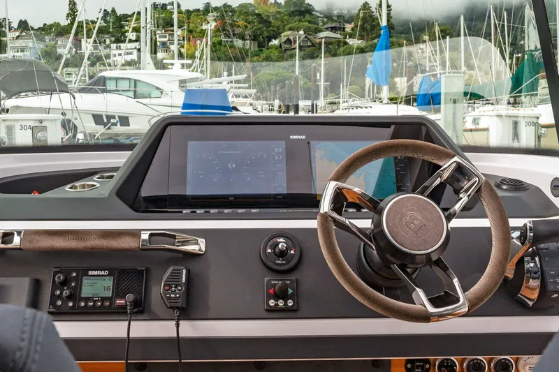 Slide: The Image of Interior view of 2021 Axopar 28 Cabin boat dashboard with steering wheel and navigation screens. - 33
