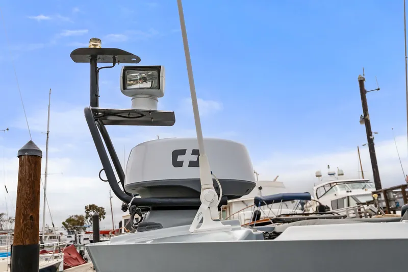 Slide: The Image of 2021 Axopar 28 Cabin boat radar and spotlight at marina. - 11