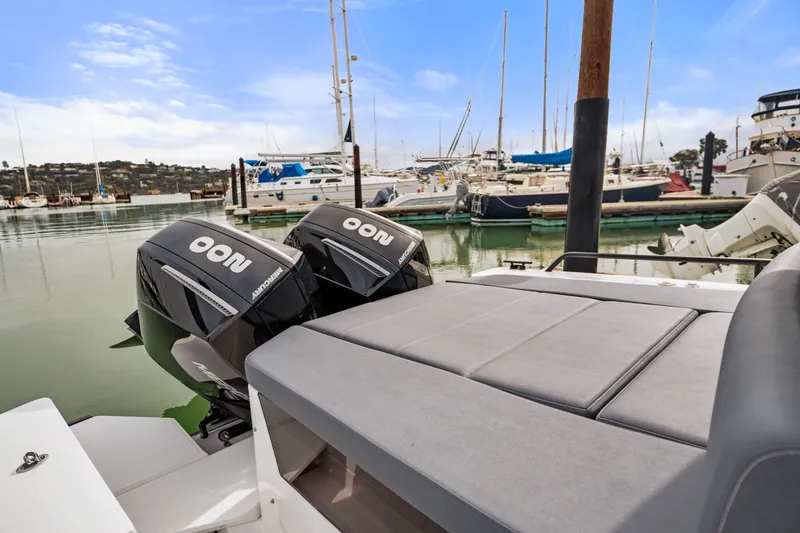 Slide: The Image of 2021 Axopar 28 Cabin boat with twin Mercury engines docked in a marina. - 9