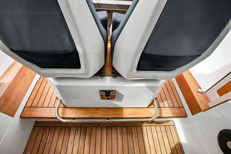 Slide: The Image of Interior view of 2021 Axopar 28 Cabin with sleek seating and wooden flooring. - 32