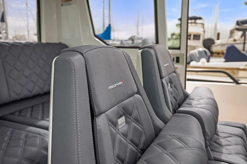 Slide: The Image of 2021 Axopar 28 Cabin interior with luxurious quilted seating and modern design. - 22