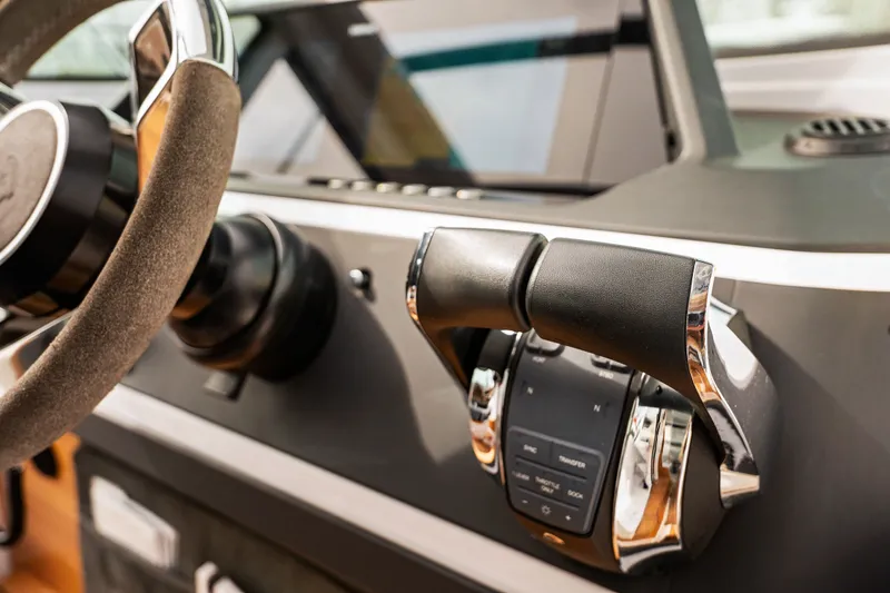 Slide: The Image of 2021 Axopar 28 Cabin dashboard with steering wheel and throttle controls. - 18