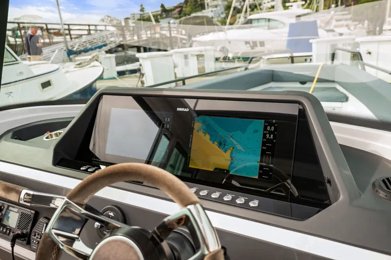 Slide: The Image of 2021 Axopar 28 Cabin dashboard with navigation display at marina. - 20